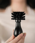 Pro-Grade Espresso Portafilter Brush For 51mm, 54mm, And 58mm Baskets with ABS Handle, held in hand, showing arc cross bristles.