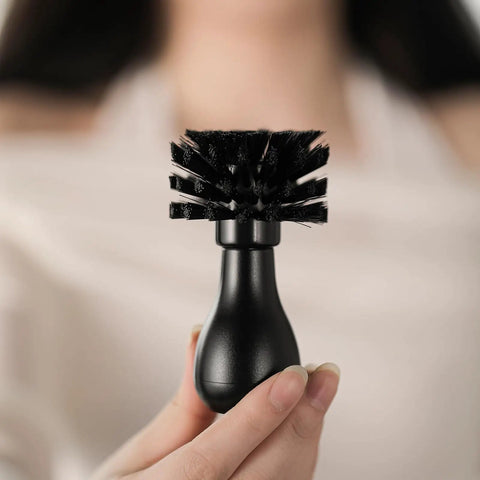 Pro-Grade Espresso Portafilter Brush For 51mm, 54mm, And 58mm Baskets with ABS Handle, held in hand, showing arc cross bristles.