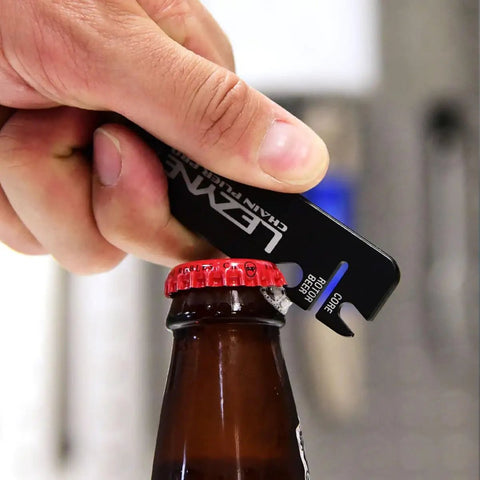 Using All In One Bike Chain Tool With Quick Link Pliers, Chain Breaker, Magnetic Link Storage, Rotor Aligner, Valve Core Wrench And Bottle Opener For Trailside Repairs to open a bottle