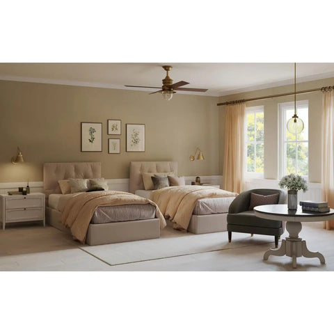 Chic bedroom with twin beds, modern neutral decor, round coffee table, and a window draped with soft beige curtains.