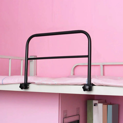 Black adjustable drill-free clip-on bed rail for adults and seniors on pink bed, sturdy metal guard for fall prevention