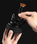 Person holding a black Rotary Espresso WDT Tool Set with wood handle, designed for precise espresso distribution.