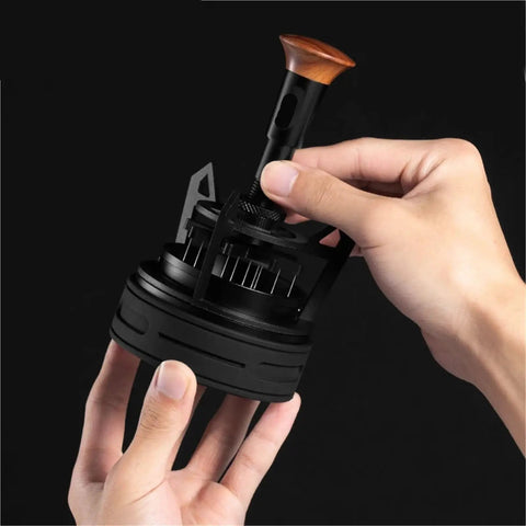 Person holding a black Rotary Espresso WDT Tool Set with wood handle, designed for precise espresso distribution.