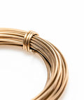 Close-up of Yellow Brass Solder Wire 5 Feet Long 20 Gauge Color Match For Brass Jewelry And Electronics Lead Free Cadmium Free Contains About 38 Percent Silver Made In USA For Soldering And Welding Pro Grade, coiled wire