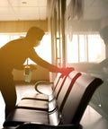 Person using Heavy Duty All Purpose Cleaner And Degreaser One Gallon to clean a chair in a commercial space.