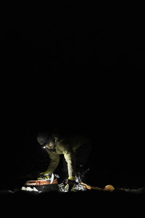 Person using Double Power Rechargeable CREE LED Headlamp with 1800 Lumens at night, showing its powerful illumination.