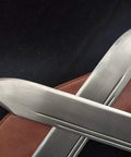 Close-up of Bart Cham Dao Damascus Steel Hand Made Sword With Brown Leather Sheath for Wing Chun Practice on a black background.