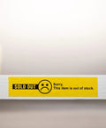 Sold out label on a store shelf indicating out of stock items, with yellow background and sad face icon.