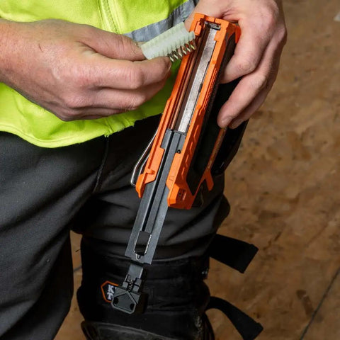 Person loading heavy duty insulated staples into stapler compatible with Stapler No 450 100 for Romex cables secure install.