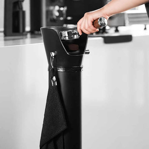 Heavy Duty Commercial Coffee Knock Box Featuring Hella Solid 6 Point 8 Liter ABS Grounds Disposal Bin, hand using knock box with towel.