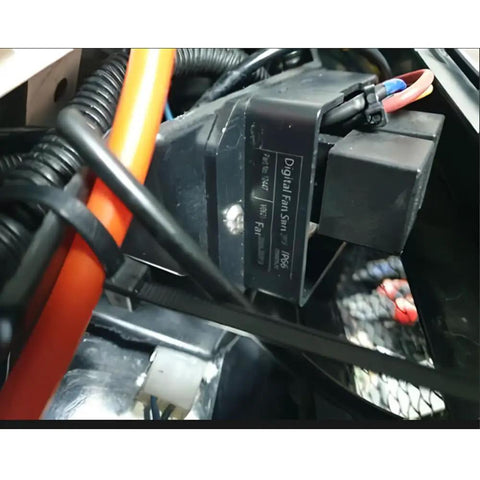 Close-up of Digital Thermostatic Fan Controller Kit for 12V and 24V Cars with connecting wires, showing label and probe