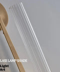 Gold Vintage Wall Sconce with Prismatic Clear Glass Tube (Metal Lamp Body) clear prismatic glass shade close-up view.