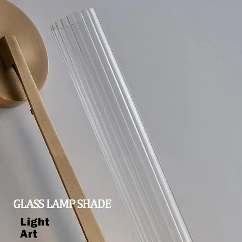 Gold Vintage Wall Sconce with Prismatic Clear Glass Tube (Metal Lamp Body) clear prismatic glass shade close-up view.