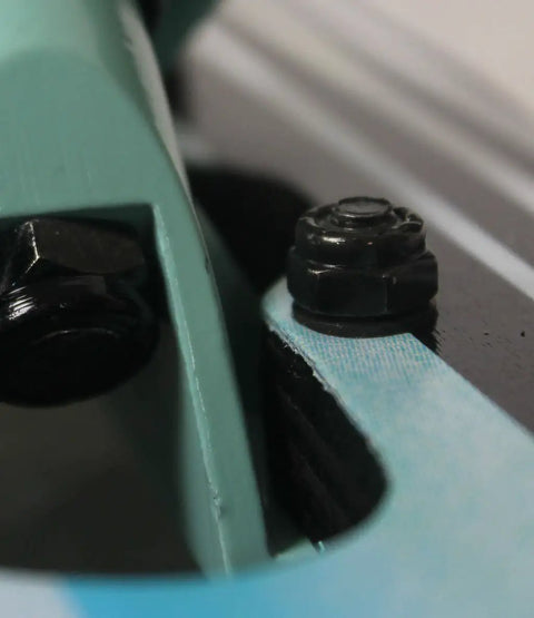 Close-up of Drop Through Longboard Hardware Kit 1 1/4 Inch Pan Head Bolts With Washers And Nuts Multicolor securing truck.