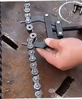 Heavy Duty Steel Motorcycle Chain Tensioner Tool Knockout Adjuster For Dirt Bikes And Cruisers being used on a motorcycle chain.