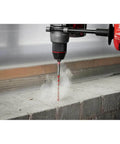 Milwaukee electric hammer drill drilling into concrete with carbide drill bit; 10-piece Shockwave set
