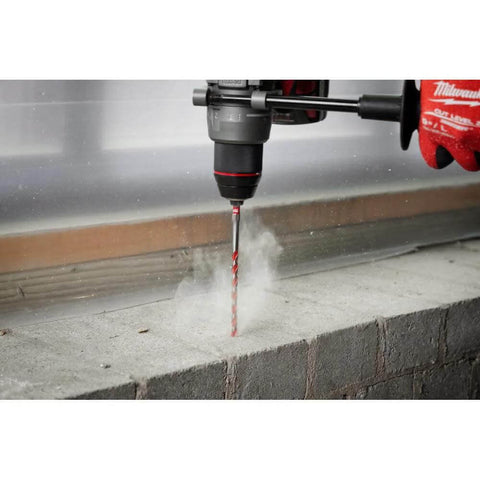 Milwaukee electric hammer drill drilling into concrete with carbide drill bit; 10-piece Shockwave set