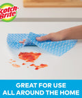 Hand cleaning spill with Reusable Kitchen Wipes, 60 Count, Rinse and Reuse Up to 10 Times, machine washable, on white surface