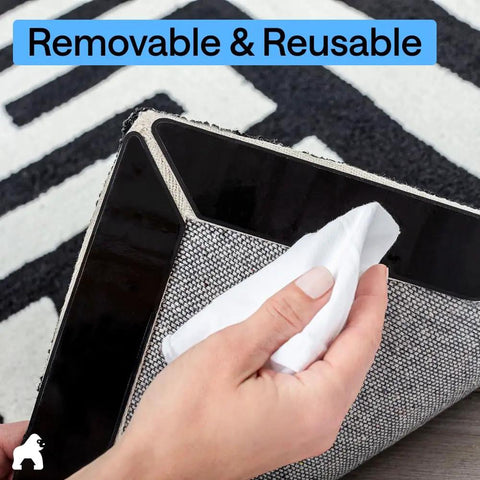 Hand removing sticker from corner of rug showing Rug Gripper Pad Kit With 24 Reusable Double Sided Stickers Keeps Rugs Flat