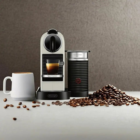 Slick Compact Coffee And Espresso Machine With Integrated Milk Frother Glossy White, coffee mug, coffee beans on counter.