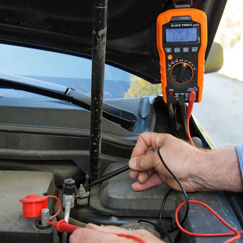 Replacement Test Lead Set, Right Angle Probes With Removable Alligator Clips in use with multimeter on car battery test