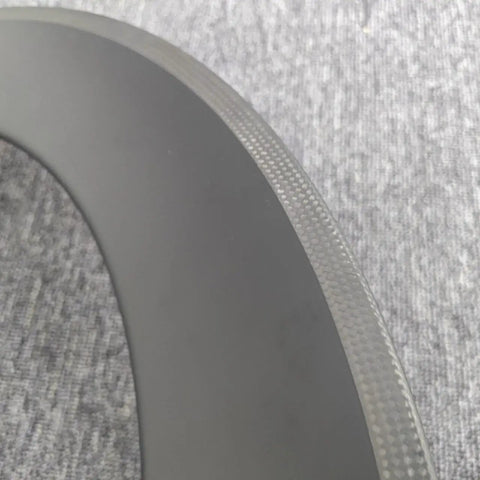 Close-up of 700C Carbon Wheelset For Road Bikes With V-Brake, 38mm Deep Rim, showing T800 carbon fiber texture and matte finish.