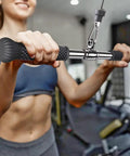 User holding Rotating Straight Bar Attachment for Cable Machines, 18 Inch with 360 Degree Swivel, non-slip rubber handles.