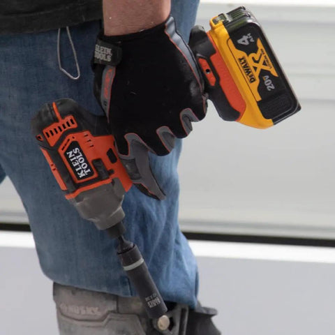 Worker holding impact driver with Impact Socket Set For One Half Inch Drive Metric 12 Point Deep Sockets Self Adjusting tool attached