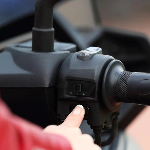 Universal Motorcycle Turn Signal Switch For Electric Bikes And Scooters With Sensitive Operation And Safe Reliability Black Plastic Replacement Handlebar Control Plug And Play Installation And Wide Compatibility shown in use