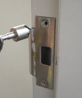 Tough As Nails Three Piece Countersink Bit Set Features Quarter Inch Stepped Shank in use on a metal door frame.