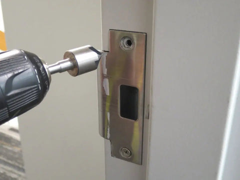 Tough As Nails Three Piece Countersink Bit Set Features Quarter Inch Stepped Shank in use on a metal door frame.