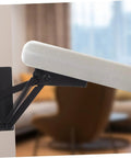 JECOMPRIS folding hinge lifting bracket, black metal with spring, installed on a cabinet door.