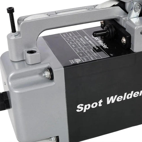 Close-up of Portable Steel Sheet Metal Spot Welder Handheld Welding Tool With Copper Tips, showing handle and label details.