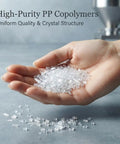 Hand holding clear polymer pellets used in manufacturing 125L Rain Barrel Alternative Blue Open Top Storage Keg for Water Storage