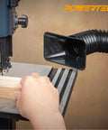 Flexible 2.5 Inch Dust Collection Hose With Left Spiral Design connected to a table saw capturing dust in a woodworking shop.