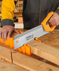 Person using Miter Box And Saw Set 14 Inch Back Saw With ABS Box For Woodworking Trim Molding And Carpentry Precision Angle Cuts 45 Degree And 90 Degree For Framing And Picture Frames Pro Grade to cut wood.