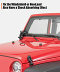 Front windshield hold-down bracket and hood bumper cushions on a red Jeep Wrangler JK/TJ; two black rubber caps.