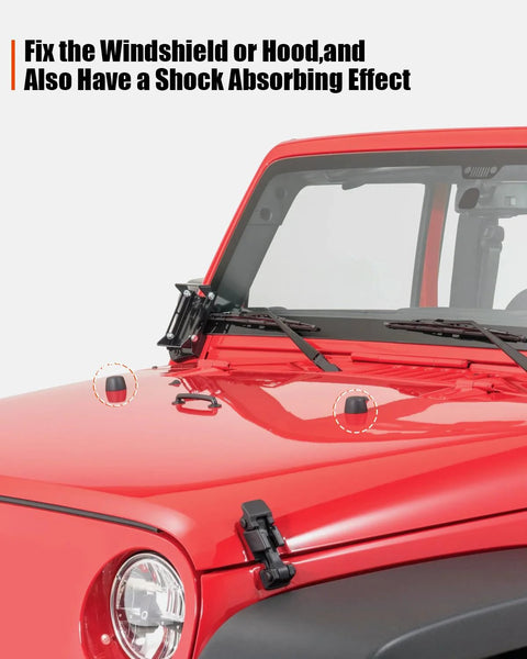 Front windshield hold-down bracket and hood bumper cushions on a red Jeep Wrangler JK/TJ; two black rubber caps.