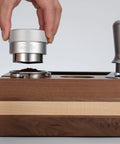 Hand using 53mm Gravity Adaptive Espresso Distributor for 54mm Portafilters, Fits Breville Bottomless Portafilter, 304 Stainless Steel Coffee Tool
