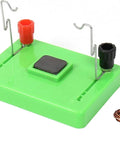 Green base of Electric Motor Model and Electromagnetic Swing Kit for Classroom Learning with metal connectors and copper coil.