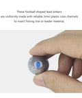 Hand holding olive lead egg sinker with blue plastic core channel visible for easy line insertion