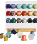 Assorted colored coffee capsules in a holder, compatible with Electric Coffee Capsule Sealing Machine For 37mm 50mm And 54mm Cups.