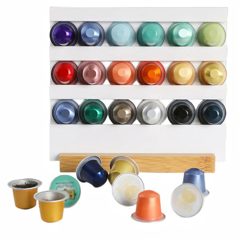 Assorted coffee capsules displayed on a rack with loose capsules in front, suitable for Pro Grade Coffee Capsule Sealer Machine.