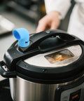Blue silicone steam diverter on pressure cooker, part of Silicone Steam Diverter For Pressure Cooker High Temperature Resistant Exhaust Vent Tube 6 Pieces Kitchen Steam Hose Set With Countertop Protection And Cabinet Protection Flexible Quick Install Steam Direction Control.