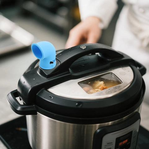 Blue silicone steam diverter on pressure cooker, part of Silicone Steam Diverter For Pressure Cooker High Temperature Resistant Exhaust Vent Tube 6 Pieces Kitchen Steam Hose Set With Countertop Protection And Cabinet Protection Flexible Quick Install Steam Direction Control.