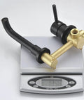 Wall Mount Bathroom Faucet Matte Black With RoughIn Valve Included Solid Brass Valve Body Corrosion And Tarnish Resistant Finish Vessel Sink Ready HighFlow Design Model S1385DI BuiltToLast Easy Install shown on weighing scale
