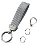 Premium Genuine Leather Car Keychain Featuring Slick Carbon Fiber Wrap And Anti Lost D Ring Built On Solid Zinc Alloy Base With Dual Split Rings For Everyday Ride Gear In Sharp Grey Finish.