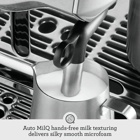 Oracle Fully Automatic Espresso Machine In Brushed Stainless Steel With 58 mm Portafilter Integrated Grinder And Slick Milk Frother showing Auto MilQ hands-free milk frothing tool.