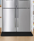 Heavy Duty Fridge Drip Pan And Leak Catcher Mat To Shield Floors From Watery Messes And Keep Your Place Bone Dry Non Slip Silicone Appliance Mat For Washer Or Freezer In Tough Black under a silver refrigerator.