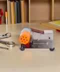 Butifulsic Portable Mini Belt Sander Electric Grinding Polishing Machine With Iron Emery Belt For Knife Sharpening Woodworking Tools on workbench with tools.